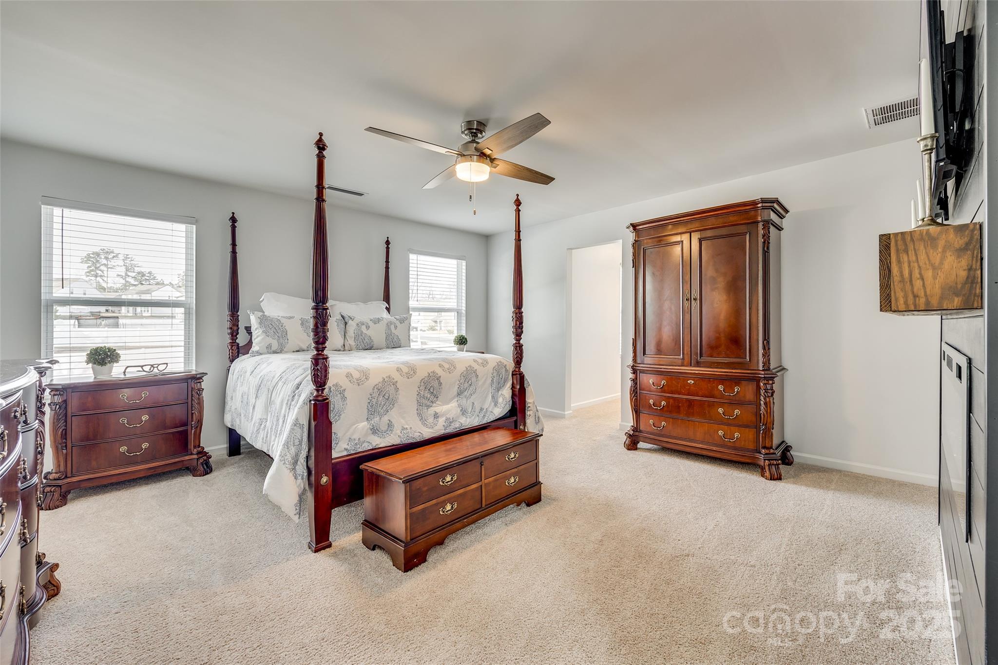 634 Gants Road York, SC 29745 - Photo 27 of 42 a spacious bedroom with a bed and a chandelier