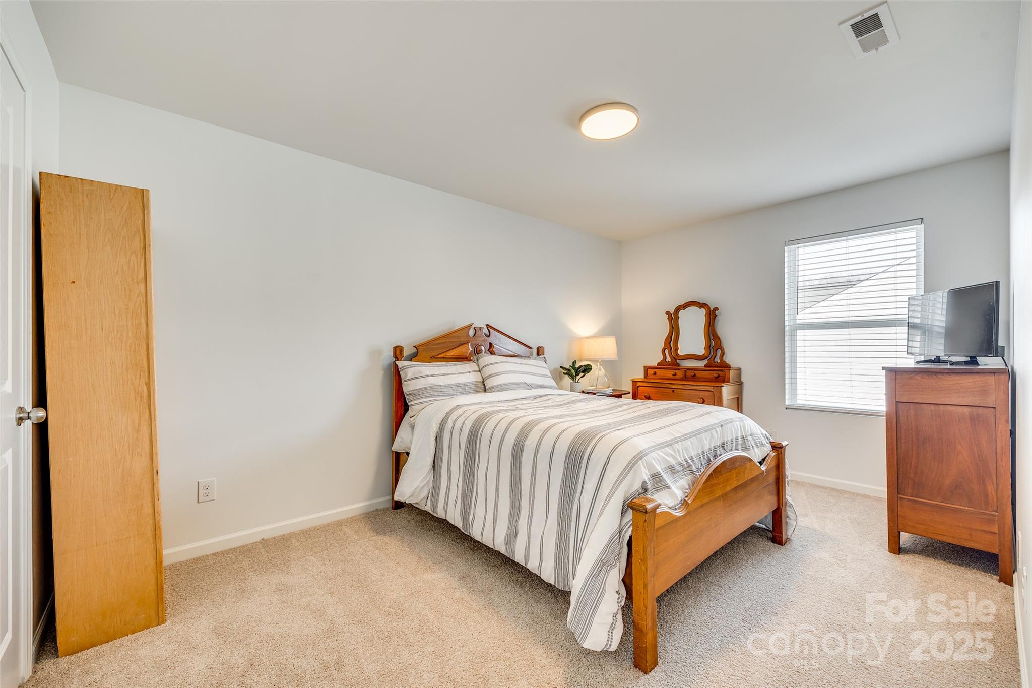 634 Gants Road York, SC 29745 - Photo 34 of 42 a bed sitting in a bedroom next to a window