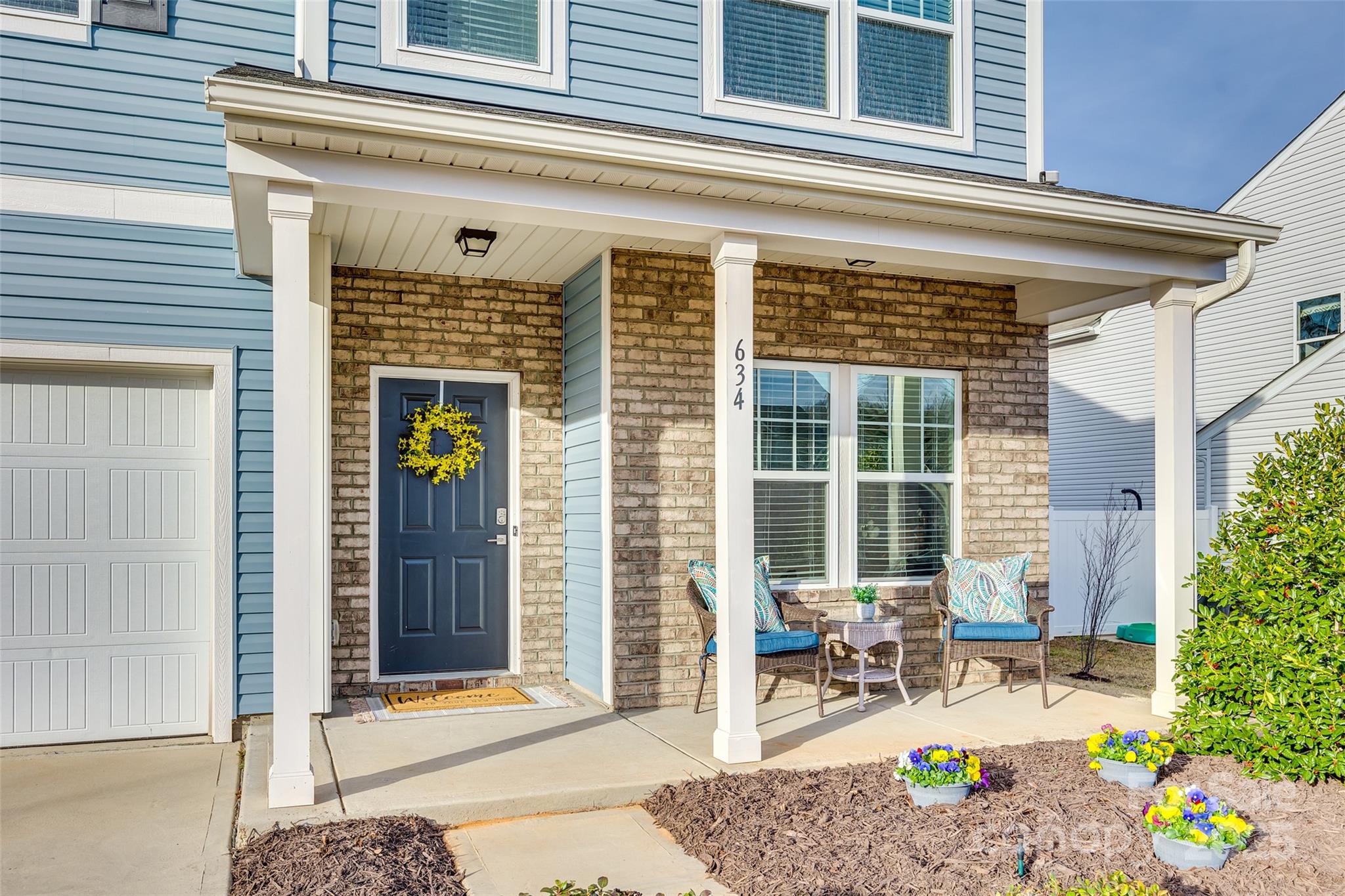 634 Gants Road York, SC 29745 - Photo 4 of 42 a front view of a house with outdoor seating and a potted plant
