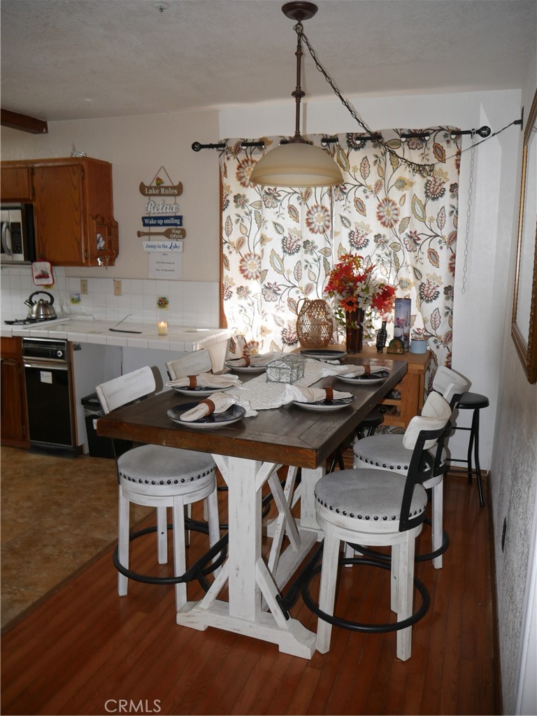 1610 North Grass Valley Road Lake Arrowhead, CA 92352 - Photo 11 of 28 a dinning table and chairs in a kitchen