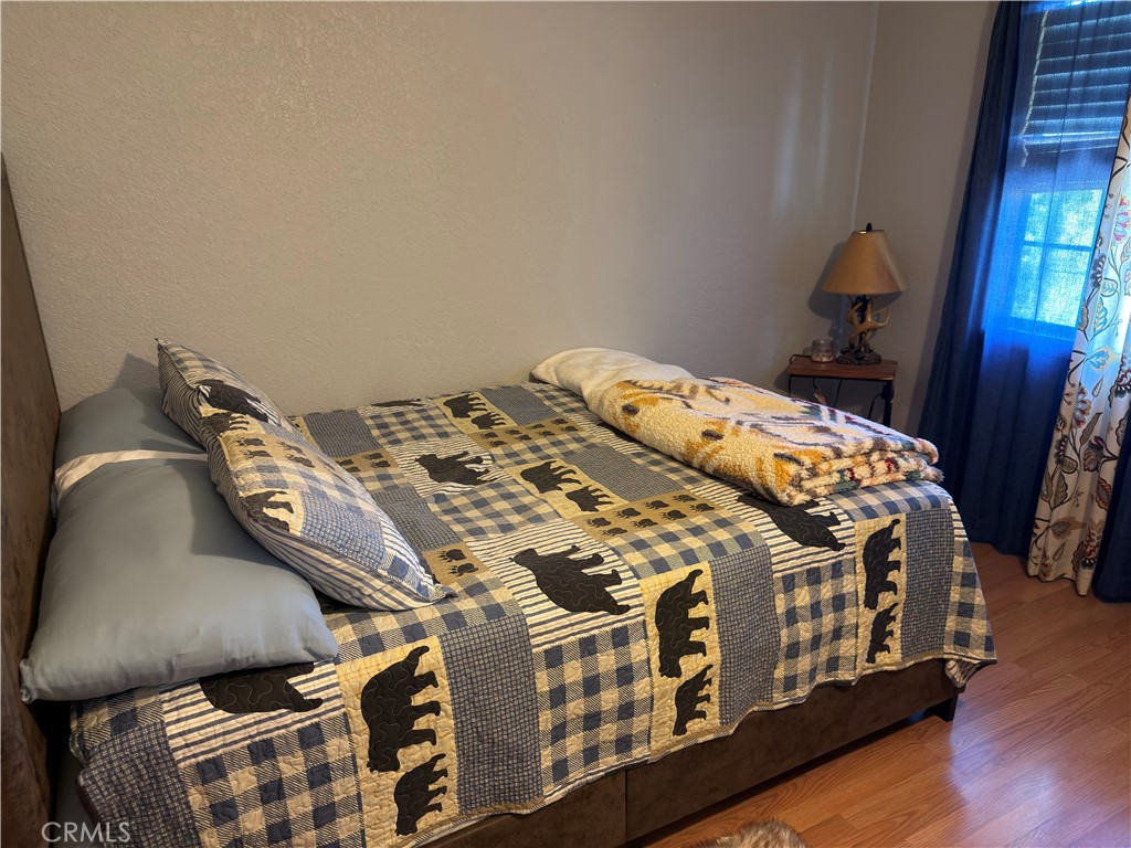 1610 North Grass Valley Road Lake Arrowhead, CA 92352 - Photo 19 of 28 a bed sitting in a bedroom next to a window