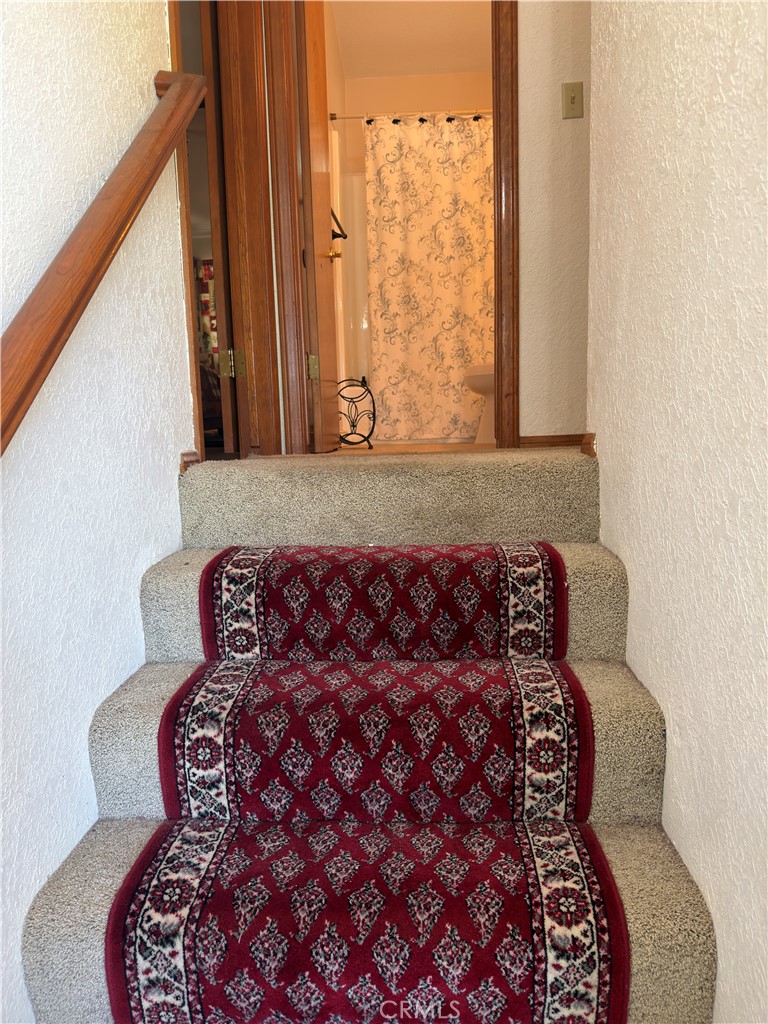 1610 North Grass Valley Road Lake Arrowhead, CA 92352 - Photo 20 of 28 a bed sitting in a bedroom next to a window