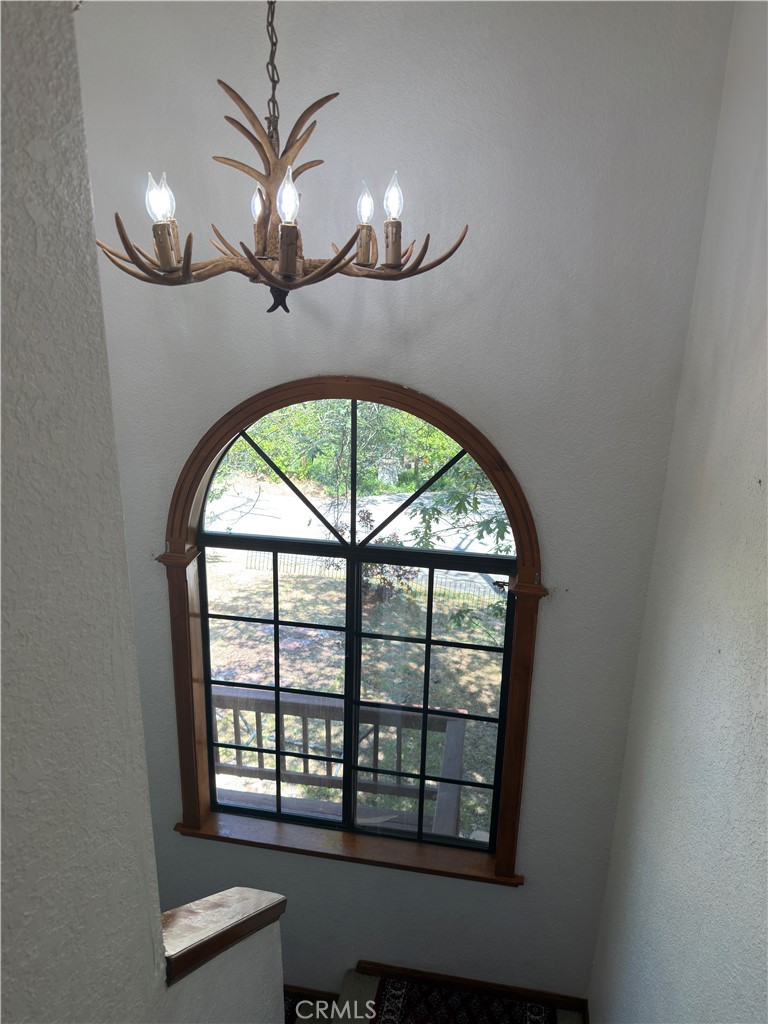 1610 North Grass Valley Road Lake Arrowhead, CA 92352 - Photo 21 of 28 an empty room with wooden floor fan and windows