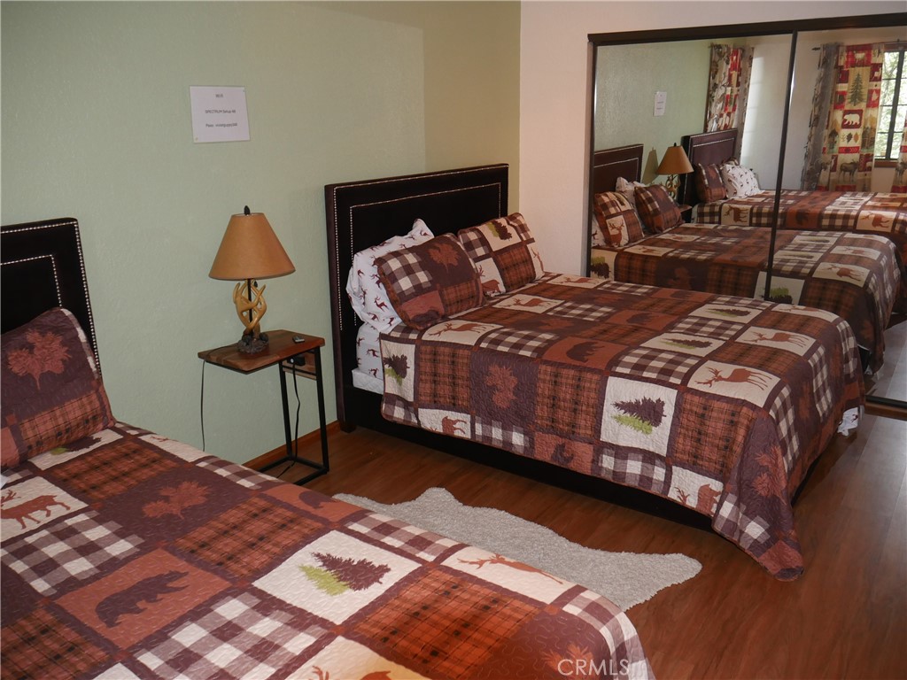 1610 North Grass Valley Road Lake Arrowhead, CA 92352 - Photo 25 of 28 a bedroom with a bed and wooden floor