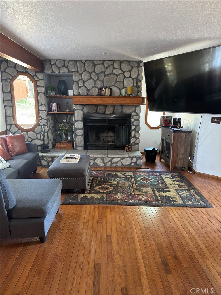 1610 North Grass Valley Road Lake Arrowhead, CA 92352 - Photo 4 of 28 a living room with furniture and a flat screen tv