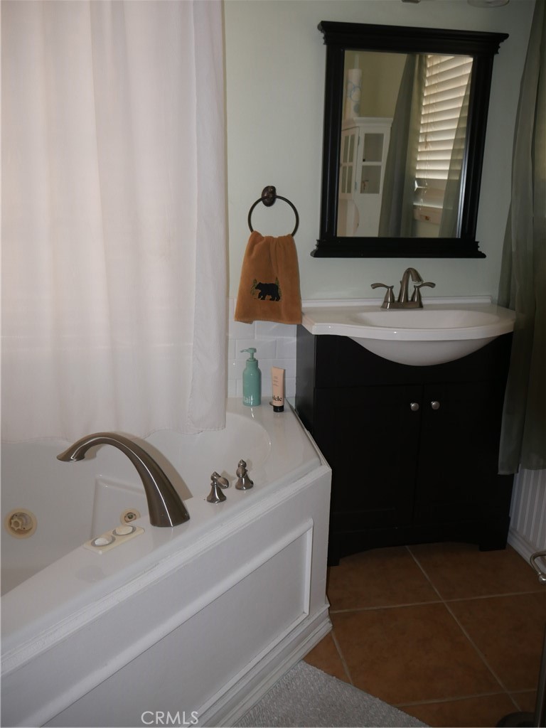 1610 North Grass Valley Road Lake Arrowhead, CA 92352 - Photo 7 of 28 a bathroom with a sink and a mirror