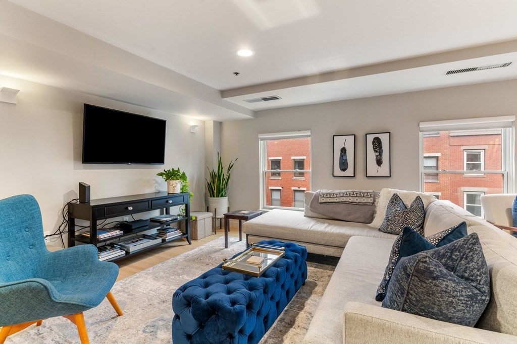 100 Fulton Street, Unit 4T Boston, MA 02109 - Photo 1 of 19 a living room with furniture and a flat screen tv
