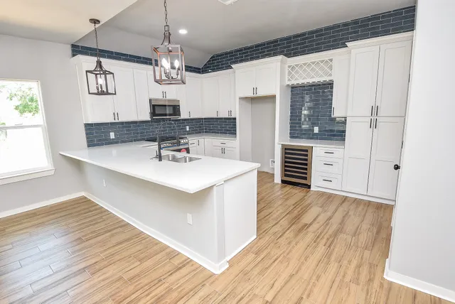 a kitchen with a sink a refrigerator and window