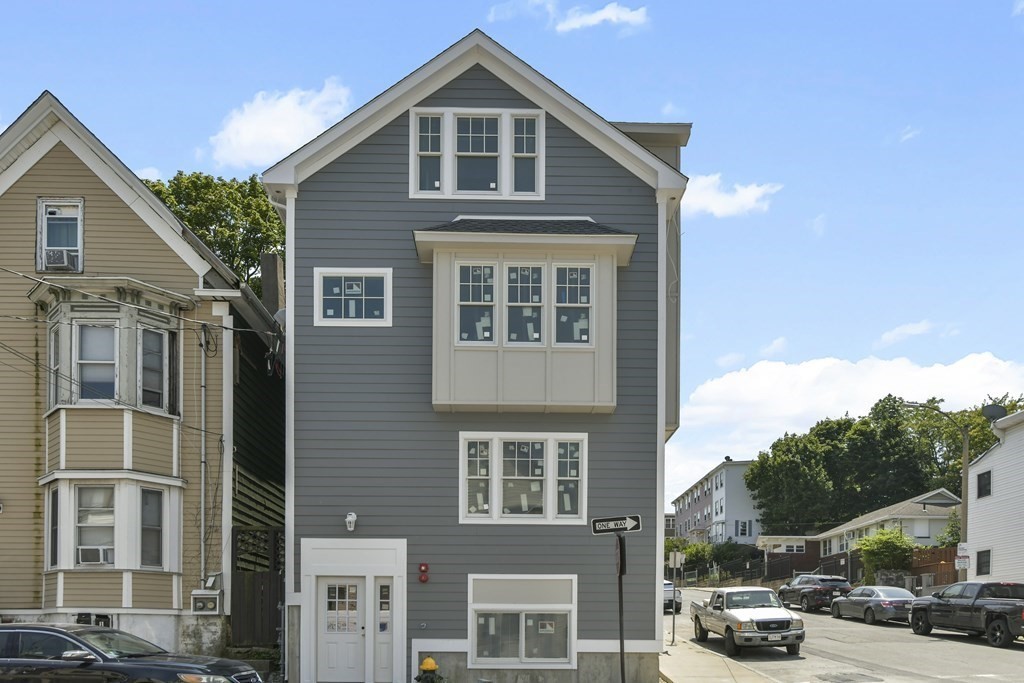 137 Falcon Street, Unit 2 Boston, MA 02128 - Photo 4 of 4 a front view of a residential apartment building with a yard