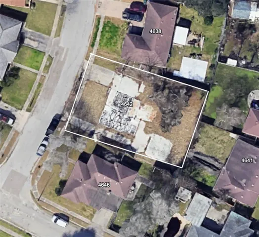 an aerial view of a house with a yard and a patio