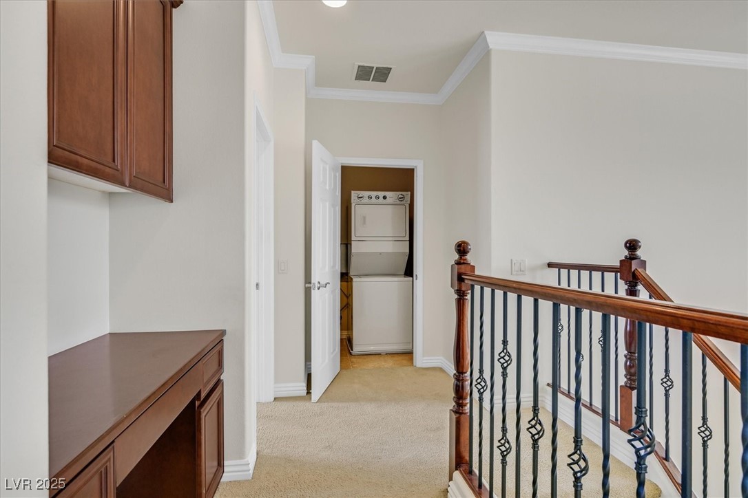 31 Via Mantova, Unit 2 Henderson, NV 89011 - Photo 15 of 30 Hall featuring ornamental molding, estacked washer and dryer, light colored carpet, and recessed lighting