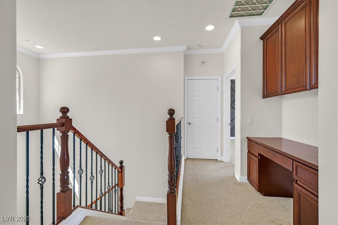 31 Via Mantova, Unit 2 Henderson, NV 89011 - Photo 16 of 30 Corridor with ornamental molding, light colored carpet, an office area, recessed lighting, and an upstairs landing