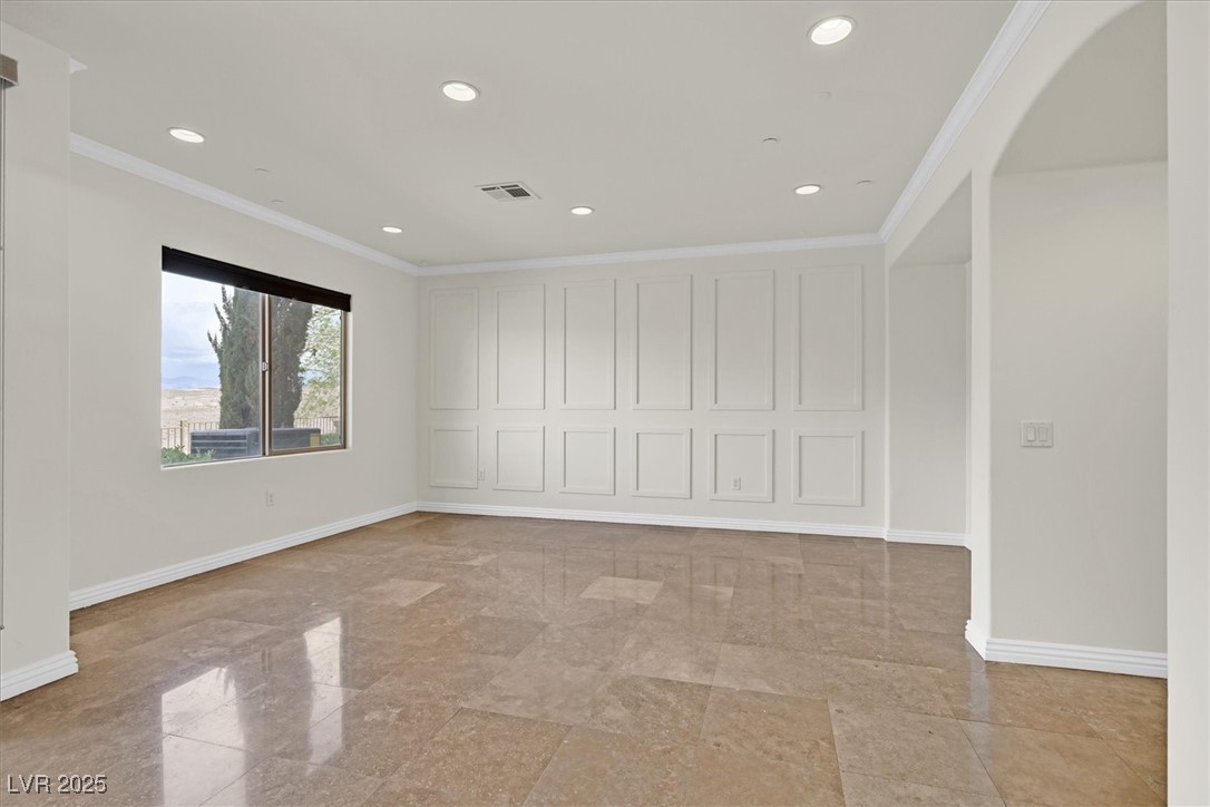 31 Via Mantova, Unit 2 Henderson, NV 89011 - Photo 2 of 30 Spare room with ornamental molding, arched walkways, and recessed lighting