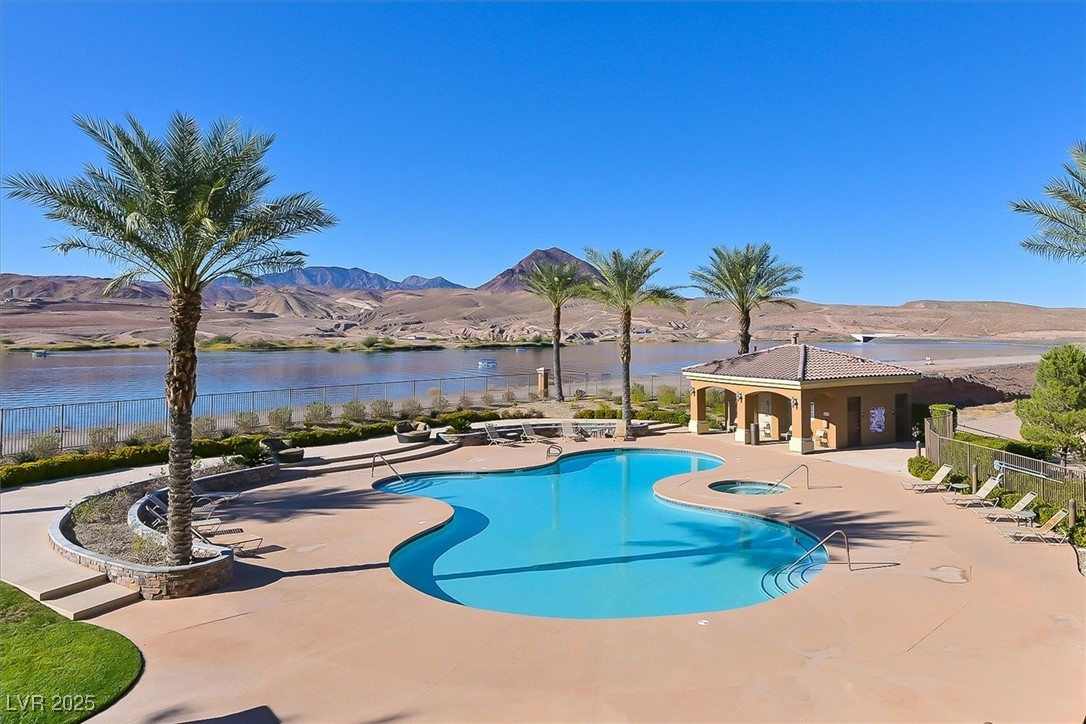 31 Via Mantova, Unit 2 Henderson, NV 89011 - Photo 28 of 30 Community pool with a patio area and a water and mountain view