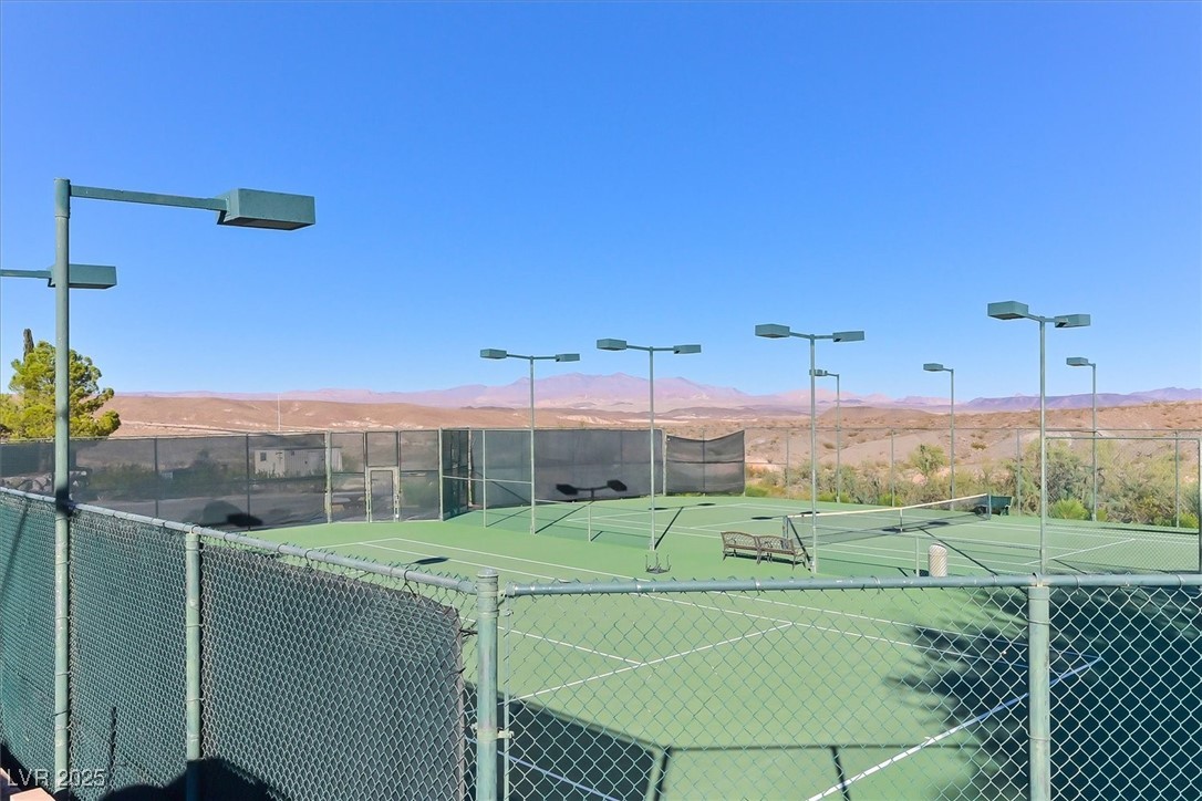 31 Via Mantova, Unit 2 Henderson, NV 89011 - Photo 30 of 30 View of tennis court featuring a mountain view and a balcony
