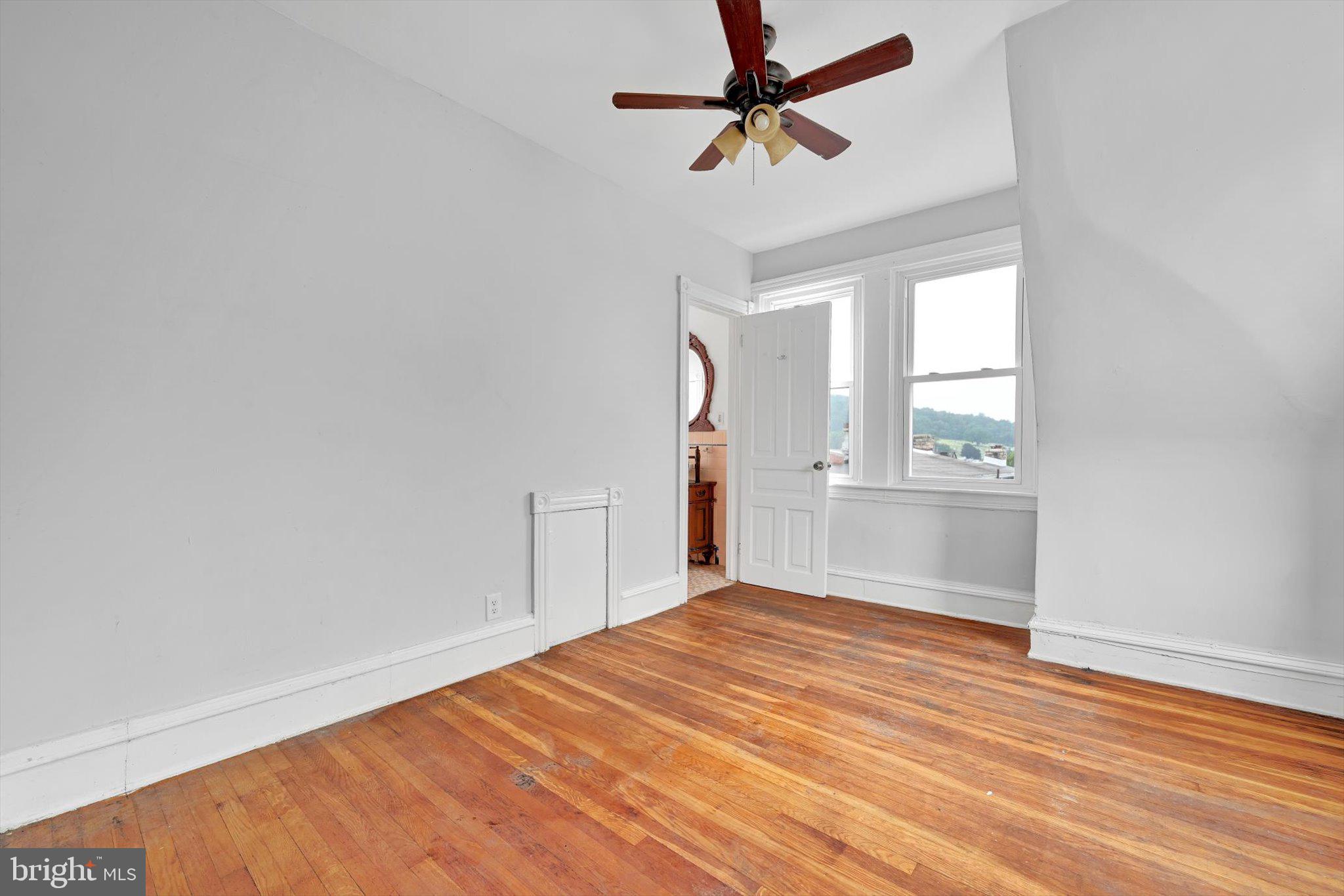 1330 Perkiomen Avenue Reading, PA 19602 - Photo 11 of 12 a view of empty room with wooden floor and fan