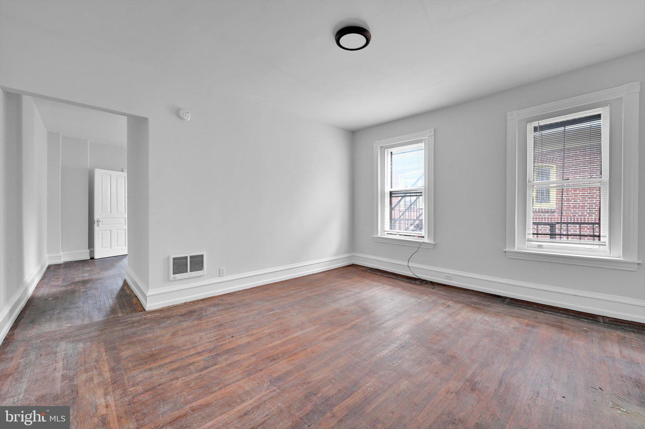 1330 Perkiomen Avenue Reading, PA 19602 - Photo 5 of 12 an empty room with wooden floor and windows