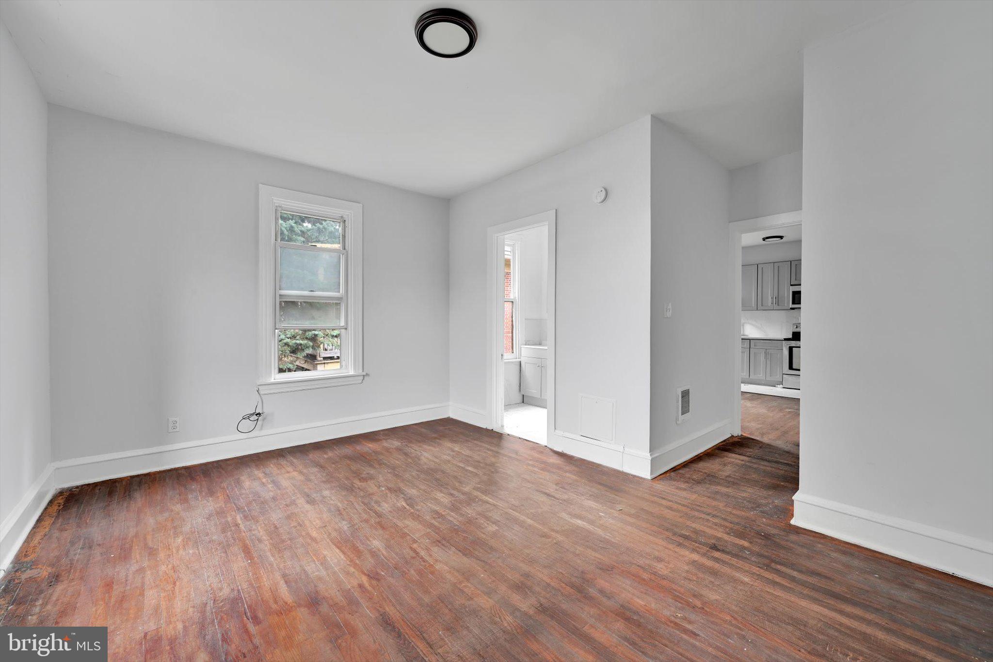 1330 Perkiomen Avenue Reading, PA 19602 - Photo 7 of 12 a view of an empty room with wooden floor and a window