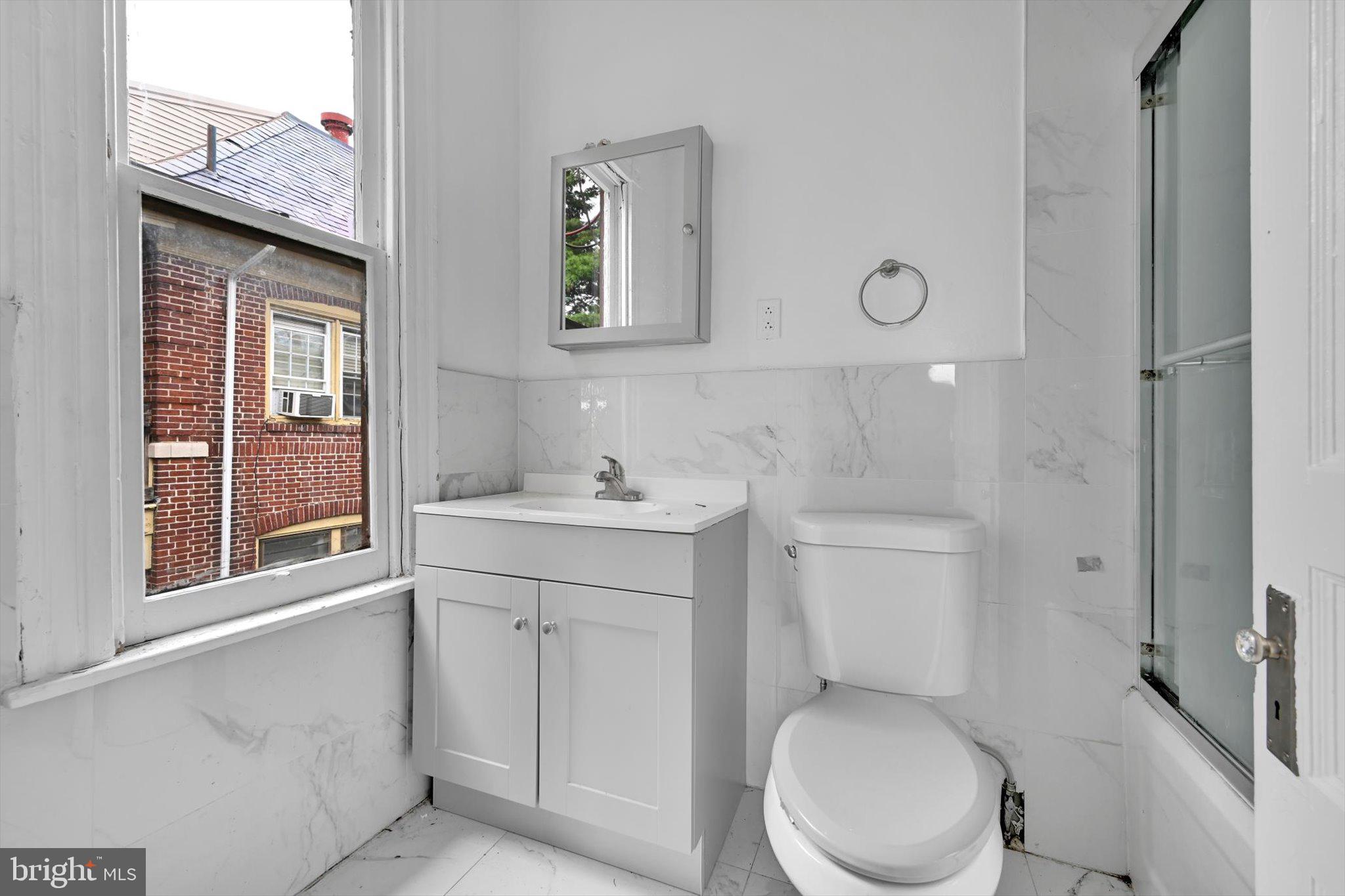 1330 Perkiomen Avenue Reading, PA 19602 - Photo 8 of 12 a bathroom with a toilet sink vanity and mirror