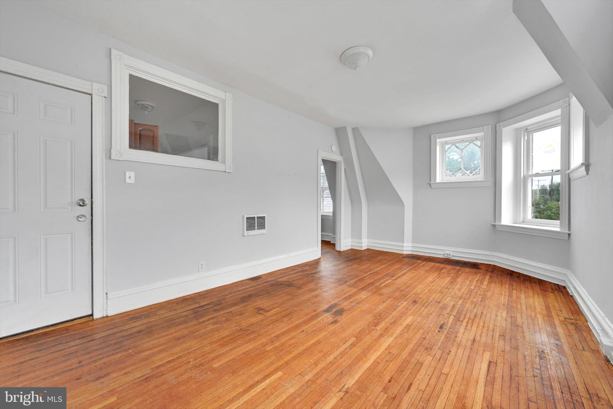 1330 Perkiomen Avenue Reading, PA 19602 - Photo 9 of 12 a view of empty room with wooden floor and fan