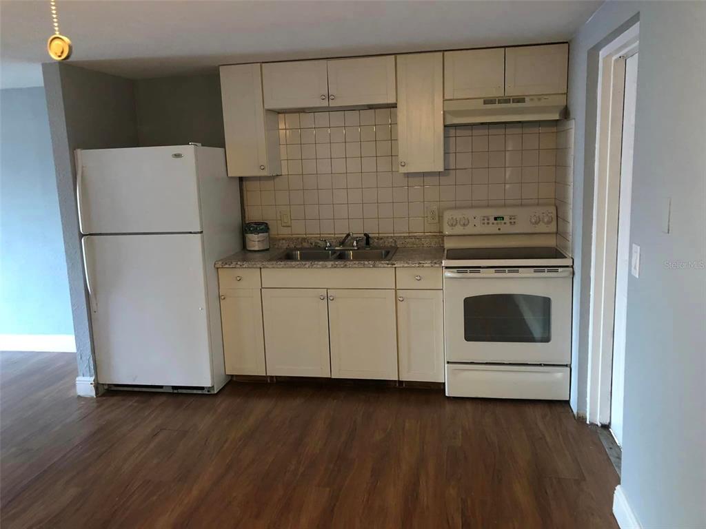 106 Karde Lane Brandon, FL 33510 - Photo 4 of 10 a white kitchen with a stove top oven