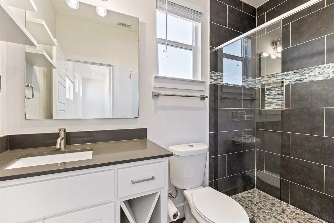 2201 Pennsylvania Avenue, Unit B Austin, TX 78702 - Photo 12 of 14 a bathroom with a sink a toilet and a mirror