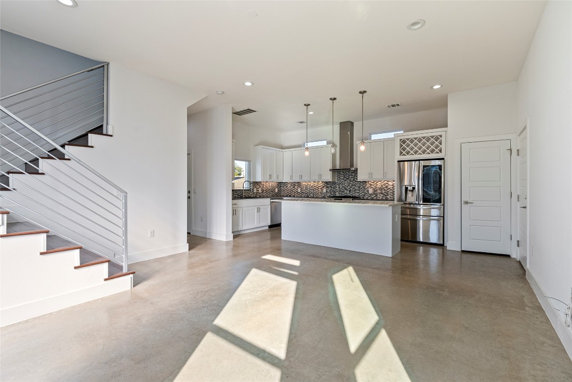2201 Pennsylvania Avenue, Unit B Austin, TX 78702 - Photo 3 of 14 a view of kitchen with kitchen island stainless steel appliances refrigerator stove microwave and cabinets