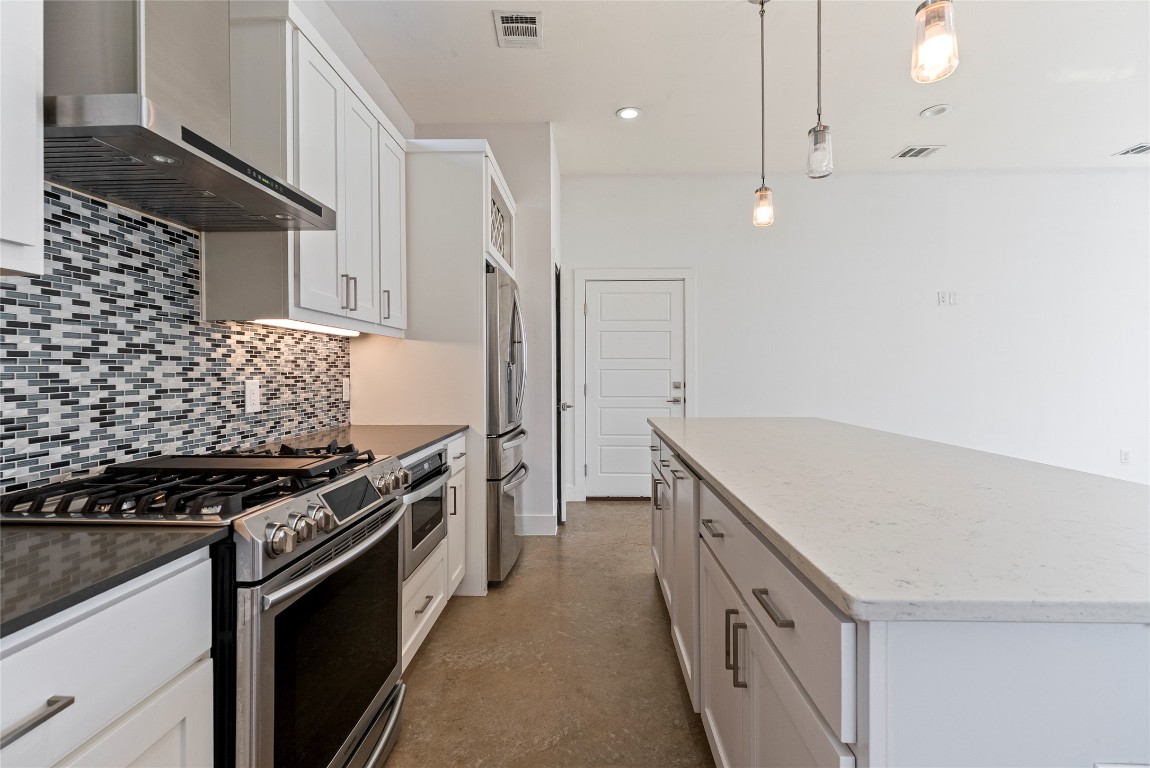 2201 Pennsylvania Avenue, Unit B Austin, TX 78702 - Photo 6 of 14 a kitchen with granite countertop a stove and a refrigerator