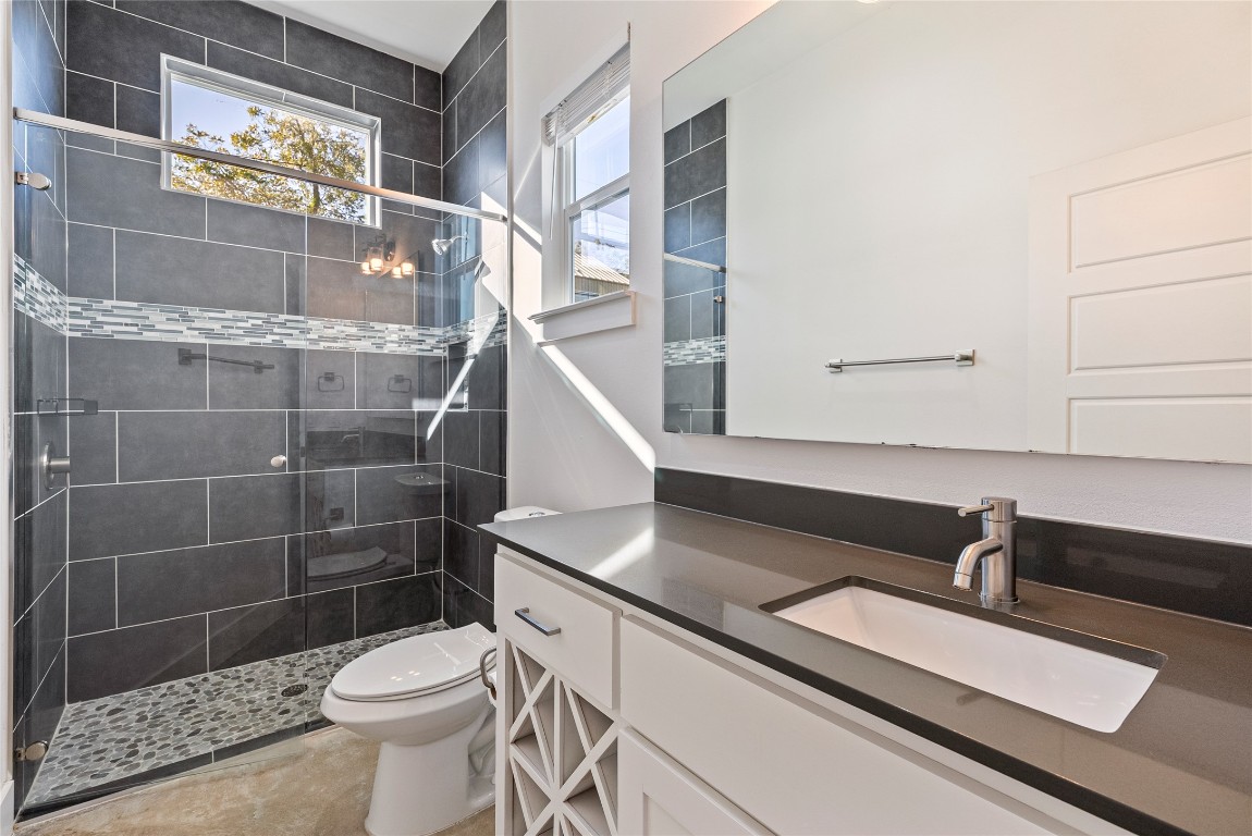 2201 Pennsylvania Avenue, Unit B Austin, TX 78702 - Photo 7 of 14 a bathroom with a sink a toilet and a shower