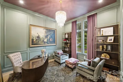 a dining room with furniture a chandelier and window