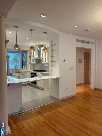 a view of a kitchen with kitchen island a counter top space a sink and cabinets