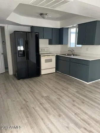 a kitchen with a refrigerator and a stove top oven