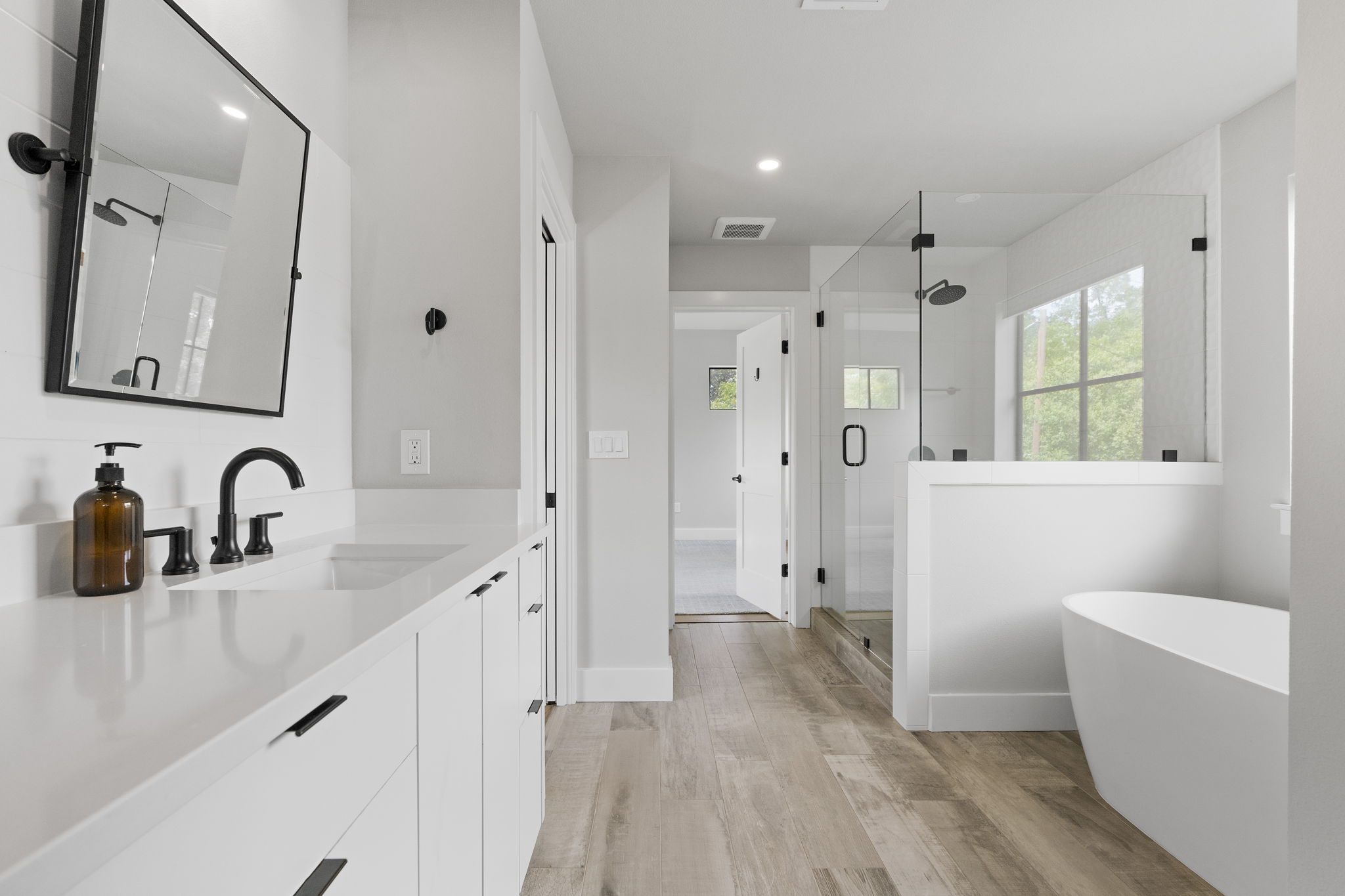 5604 Bull Creek Road Austin, TX 78756 - Photo 19 of 39 Soaking tub, separate walk in shower and dual vanities make for a luxurious primary ensuite.
