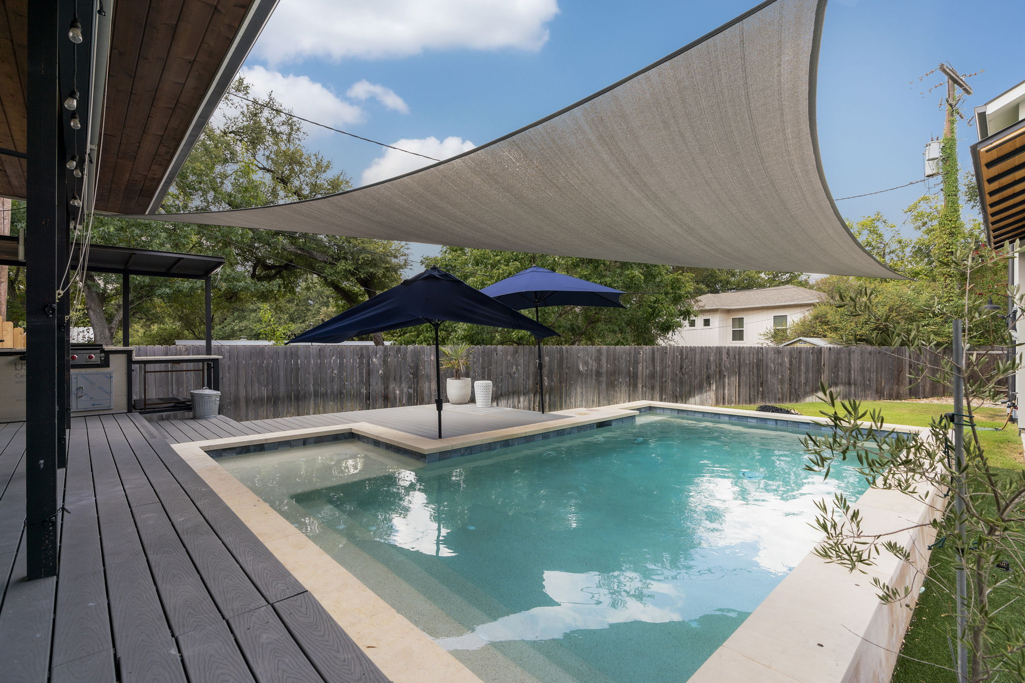 5604 Bull Creek Road Austin, TX 78756 - Photo 3 of 39 Lots of shade options for summertime! The outdoor kitchen offers a sink, grill and a Big Green Egg.