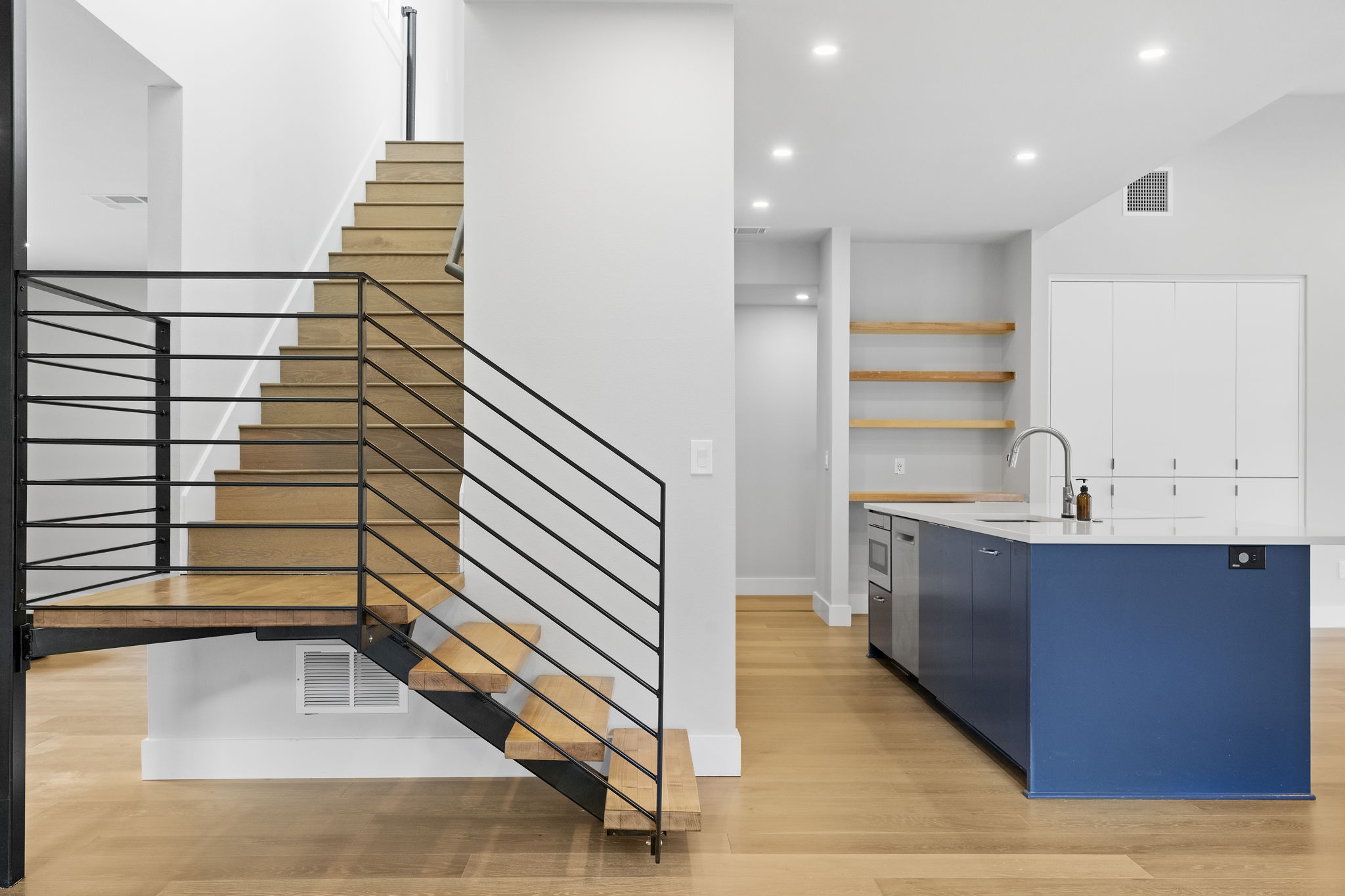 5604 Bull Creek Road Austin, TX 78756 - Photo 10 of 39 Lovely floating staircase ties this shared space together.