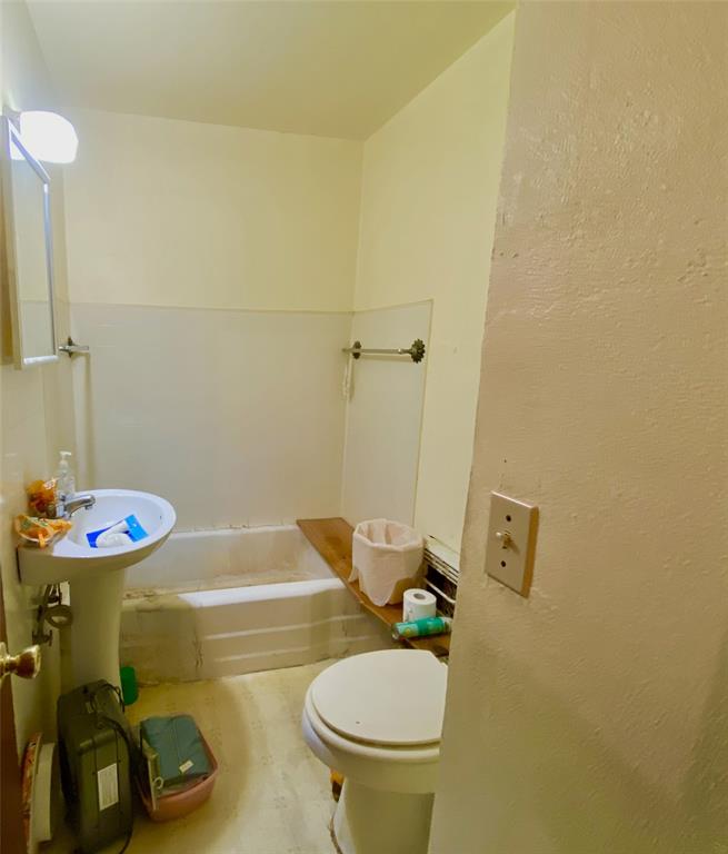 403 Mockingbird Street Chico, TX 76431 - Photo 7 of 25 a bathroom with a sink and a toilet
