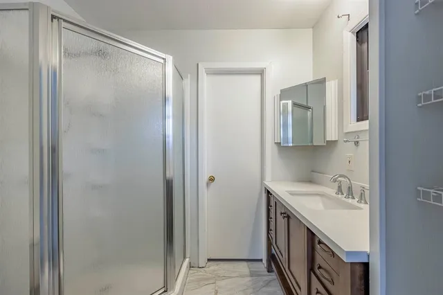 a bathroom with a double vanity sink and mirror