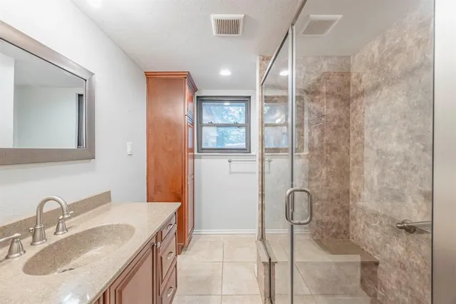 a bathroom with a sink and shower