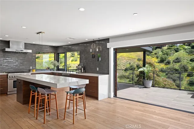 a kitchen with a sink and wooden floor