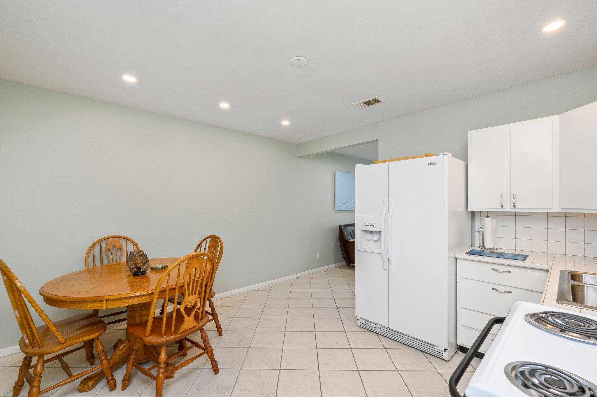 133 Smith Street Crestview, FL 32539 - Photo 12 of 28 a kitchen with a refrigerator and a stove top oven