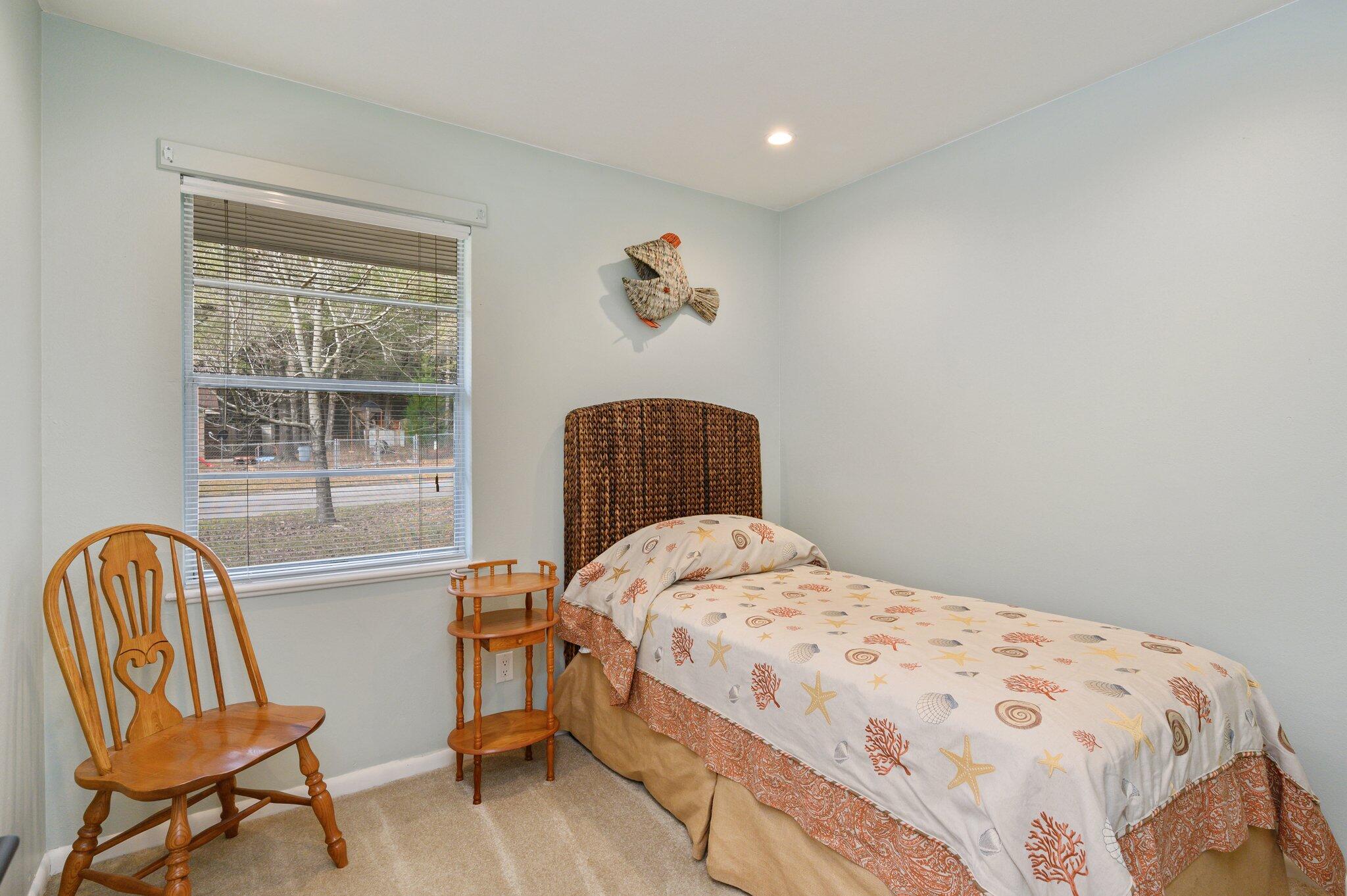 133 Smith Street Crestview, FL 32539 - Photo 15 of 28 a bedroom with a bed and chair