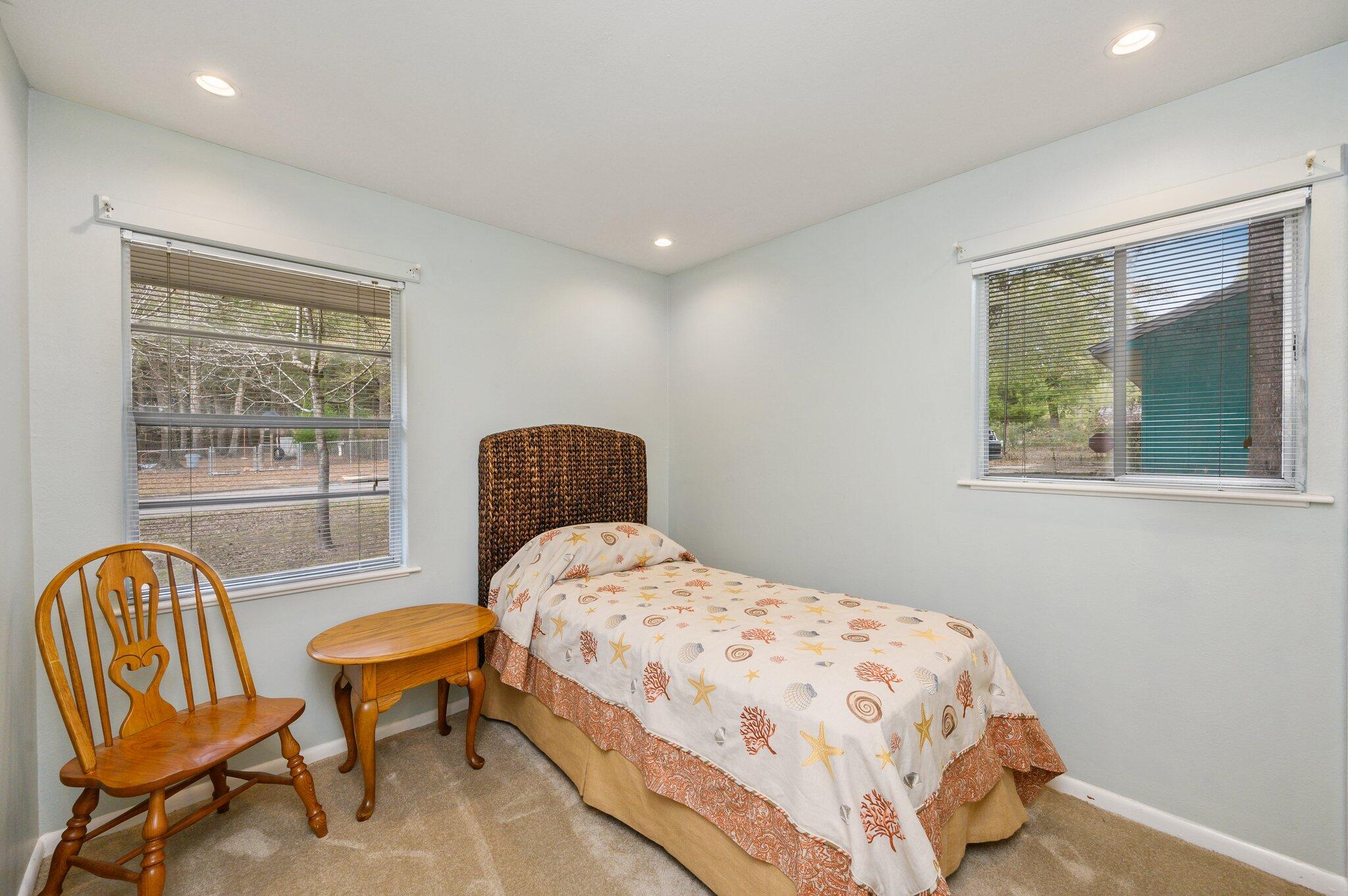 133 Smith Street Crestview, FL 32539 - Photo 17 of 28 a bedroom with a bed and chair next to a window