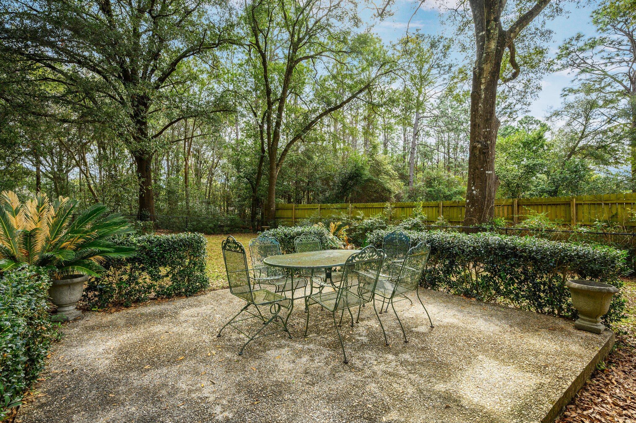 133 Smith Street Crestview, FL 32539 - Photo 23 of 28 a view of a patio with table and chairs potted plants and large tree