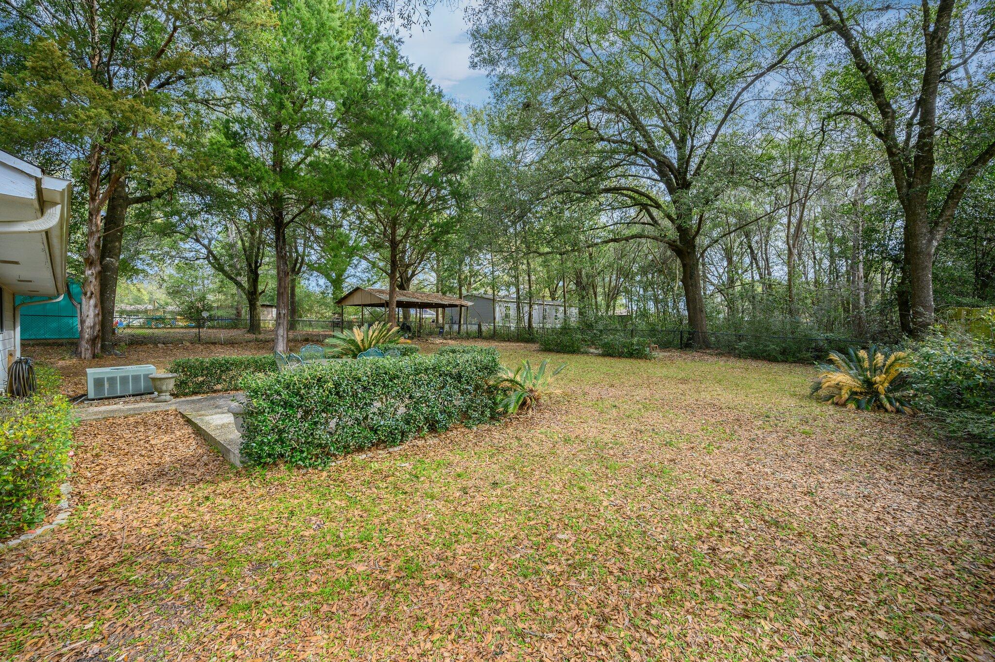 133 Smith Street Crestview, FL 32539 - Photo 24 of 28 a view of a yard with plants and trees