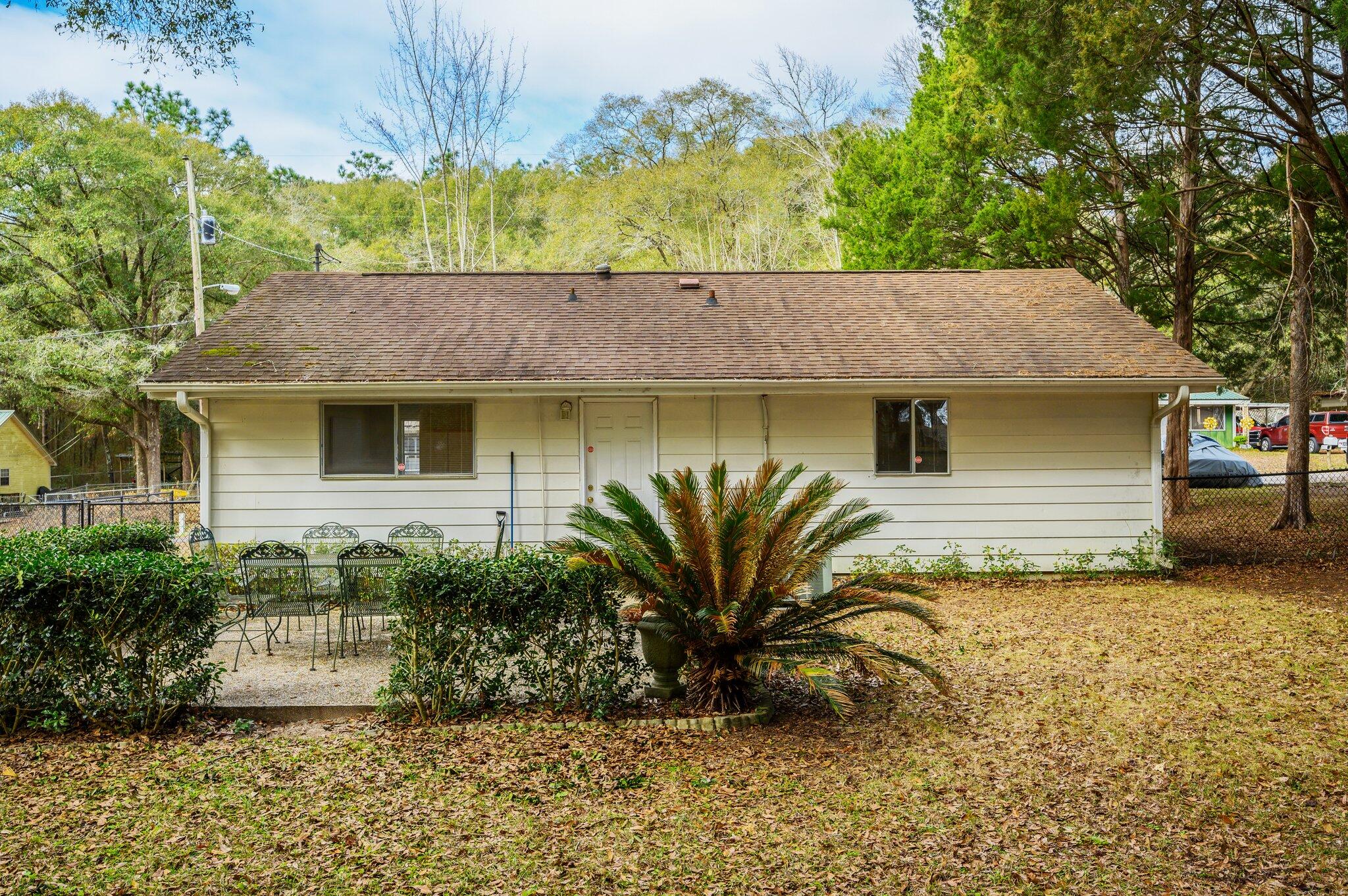 133 Smith Street Crestview, FL 32539 - Photo 26 of 28 a view of a house with a yard plants and large tree