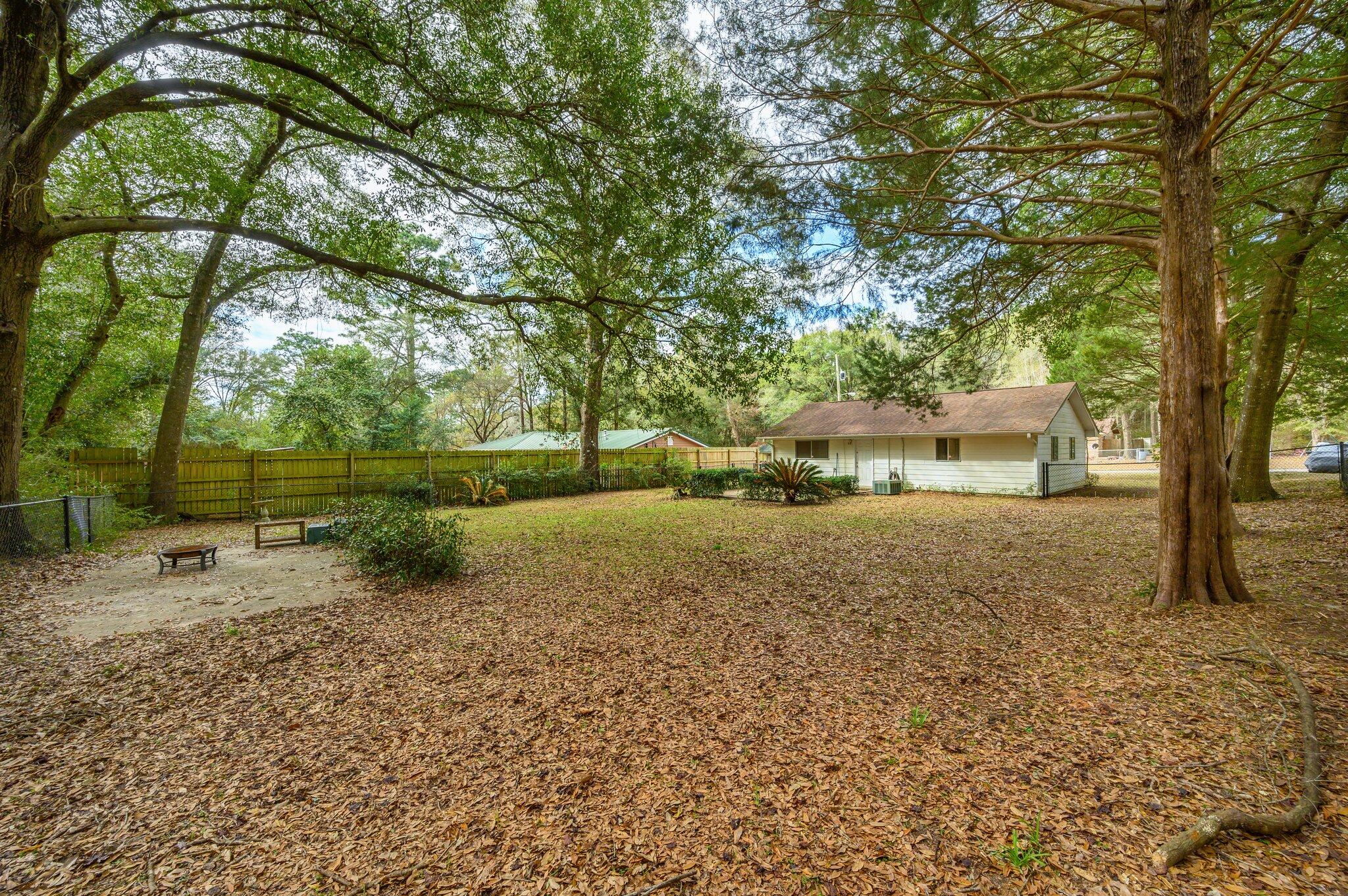 133 Smith Street Crestview, FL 32539 - Photo 27 of 28 a backyard of a house with lots of green space