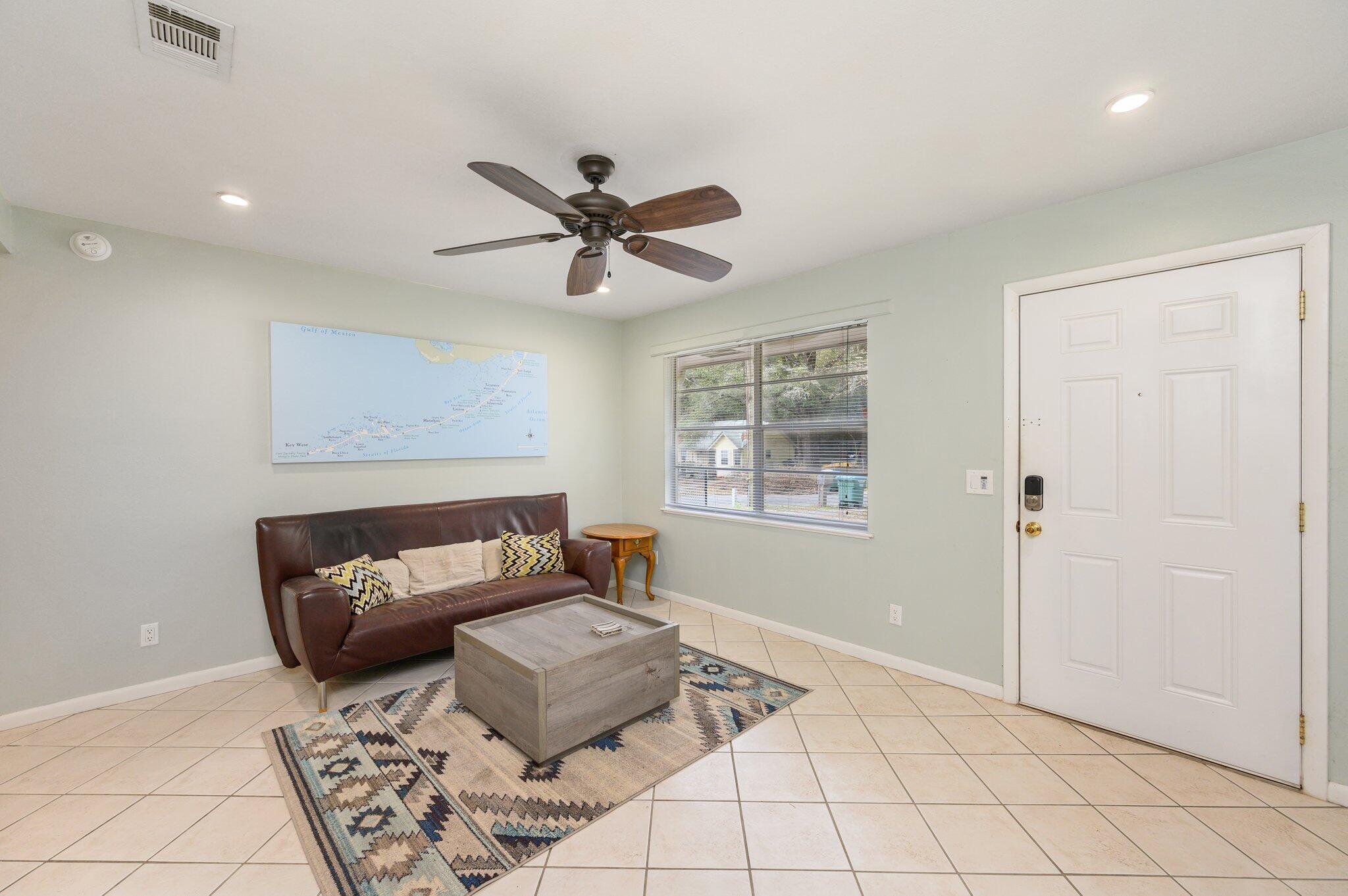 133 Smith Street Crestview, FL 32539 - Photo 6 of 28 a living room with furniture and a chandelier