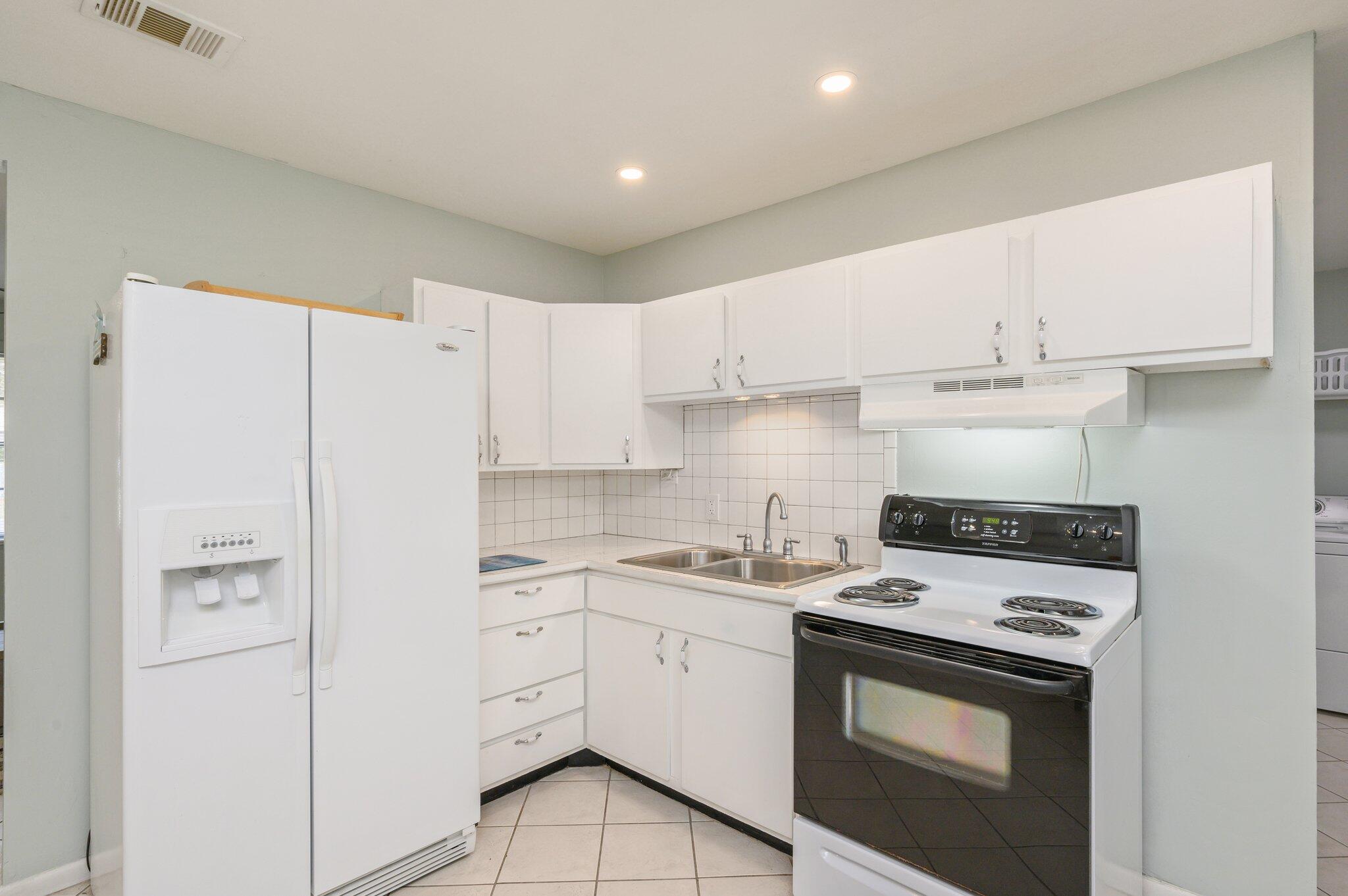133 Smith Street Crestview, FL 32539 - Photo 10 of 28 a kitchen with cabinets appliances a sink and a counter top space