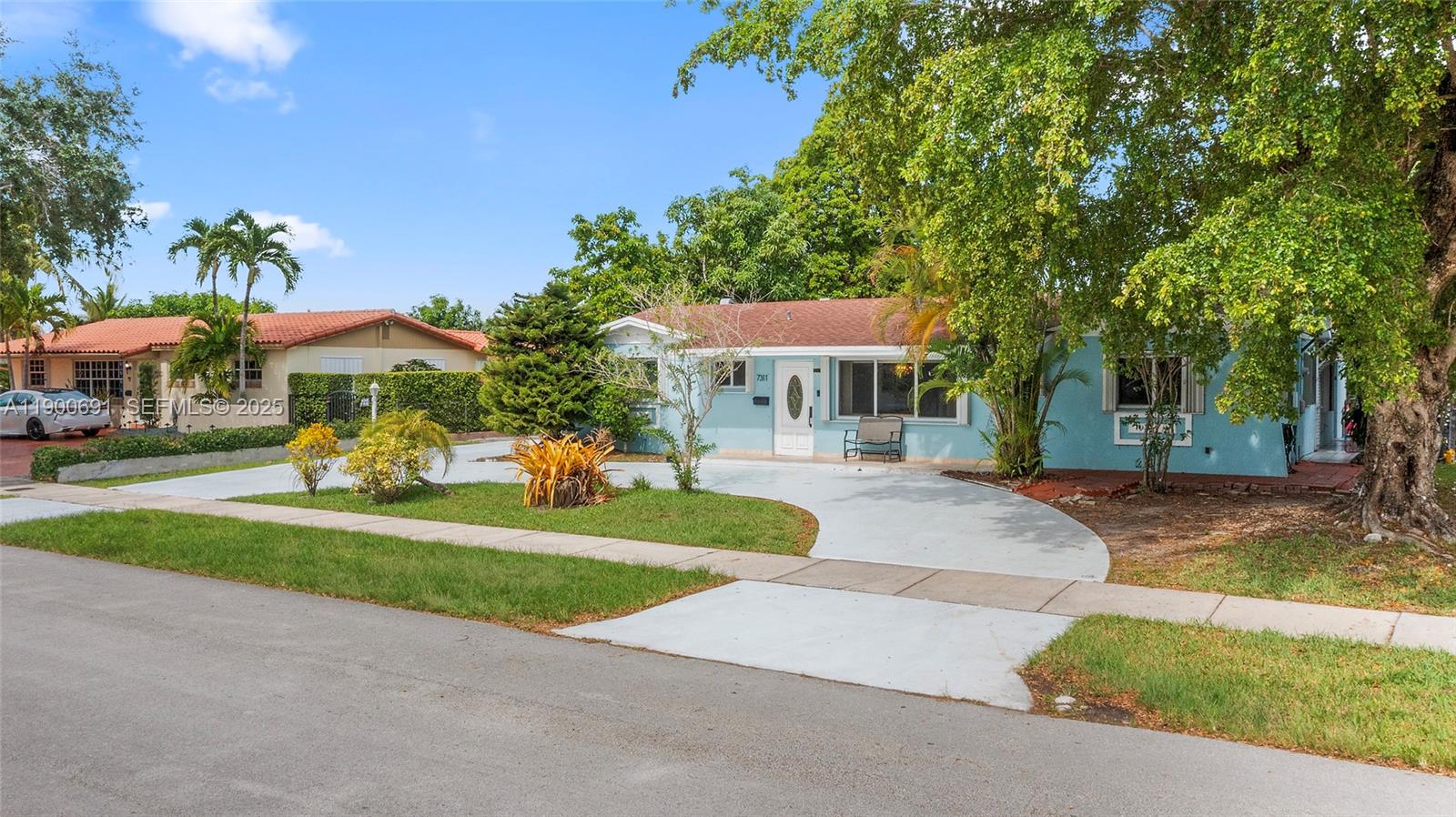 7311 Southwest 139th Avenue Miami, FL 33183 - Photo 1 of 37 a front view of a house with a yard table and chairs