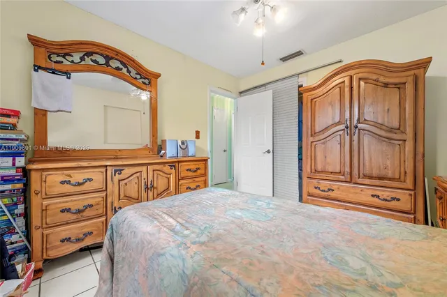 a bedroom with a bed and a dresser